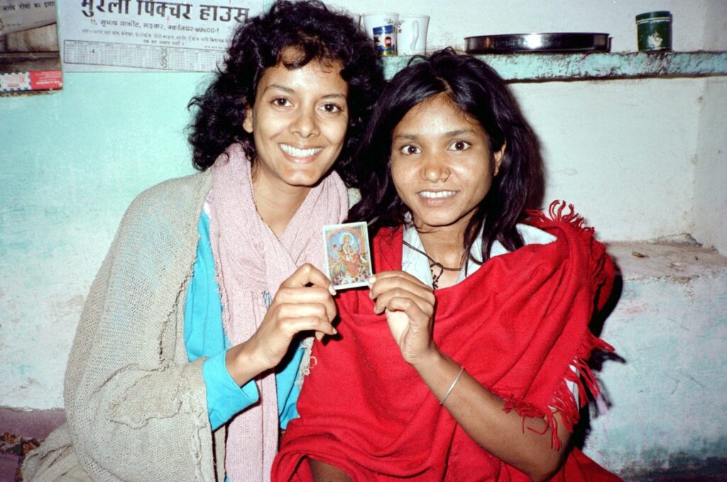 Phoolan Devi & Susie Coelho with Durga Image - 1983 Susie Coelho and Phoolan Devi smiling and holding a small image of the goddess Durga, 1983
