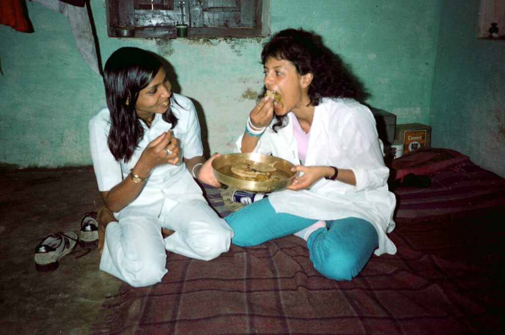 Eating with -pPhoolan Devi in Jail - 1983 Phoolan Devi and Susie Coelho sharing food from a brass plate while sitting on the floor in jail, 1983