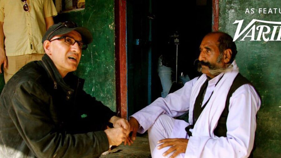Director Hossein Martin Fazeli talks with a seated man during filming, with the words ‘As featured in Variety India’.